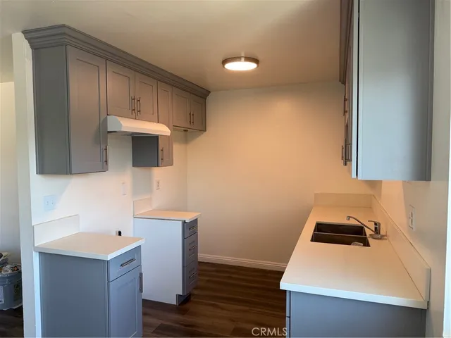 a kitchen with a sink a stove and cabinets