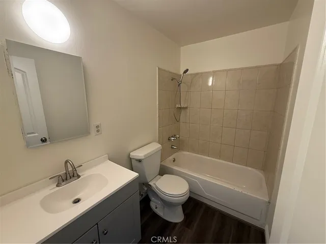 a bathroom with a sink toilet a mirror and shower