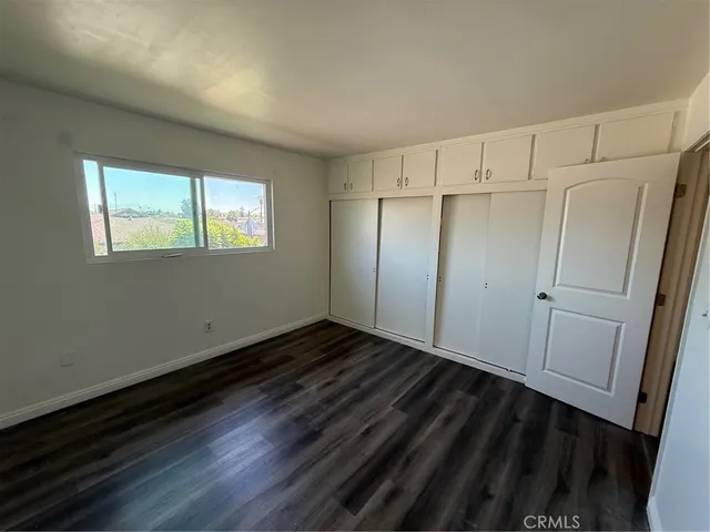 a view of a room with wooden floor and window