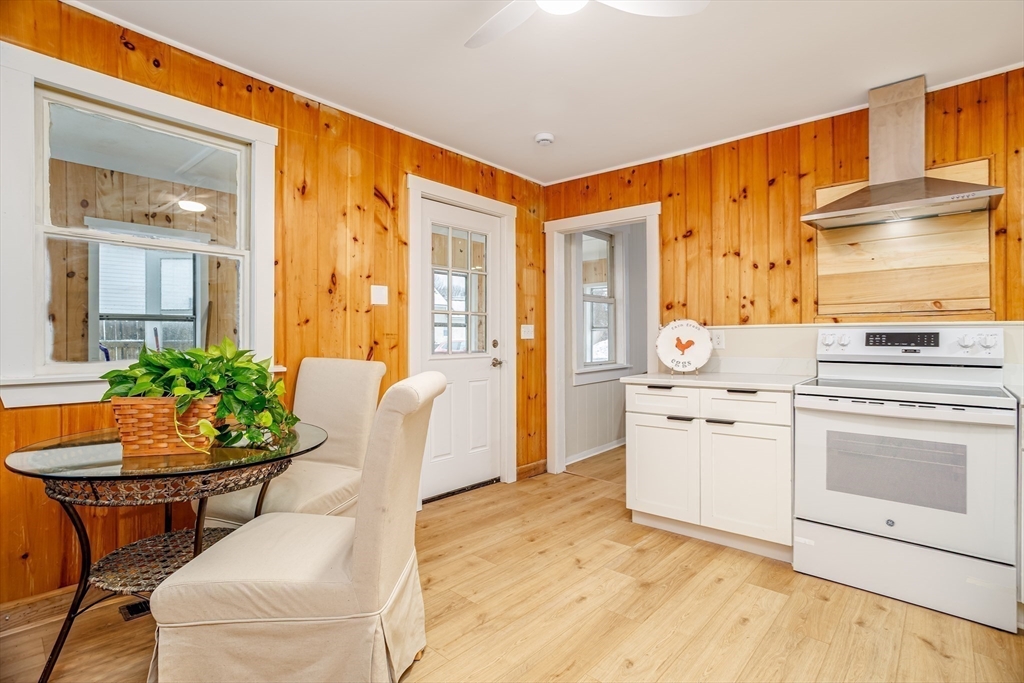 169 Spruce Street Winchendon, MA 01475 - Photo 3 of 32 a kitchen with stainless steel appliances kitchen island granite countertop a table and chairs