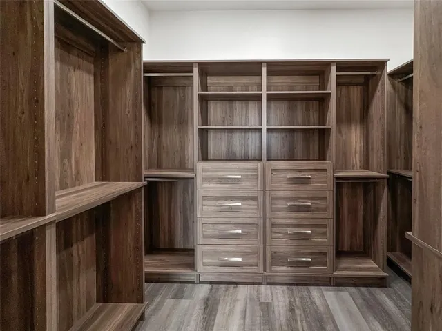 a view of walk in closet with clothes