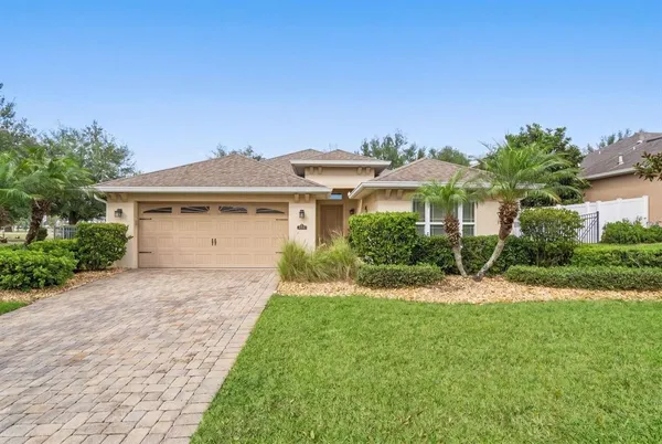a front view of a house with a yard and garage