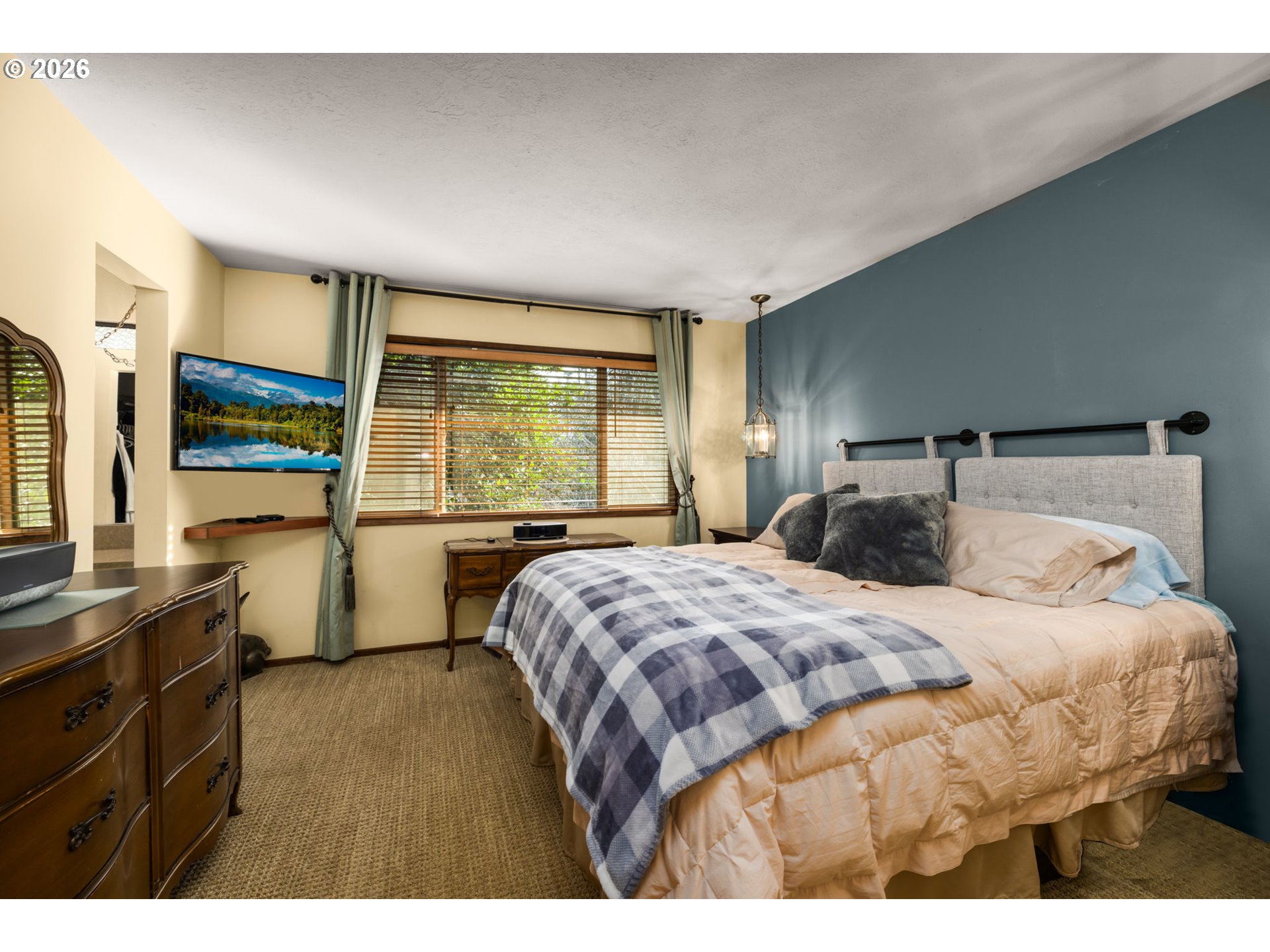 16020 Southeast Monner Road Happy Valley, OR 97086 - Photo 16 of 38 a bedroom with a large bed and a large window