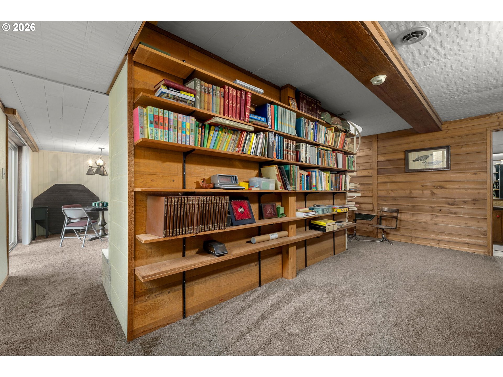16020 Southeast Monner Road Happy Valley, OR 97086 - Photo 25 of 38 a living room with furniture a bookshelf and a book shelf