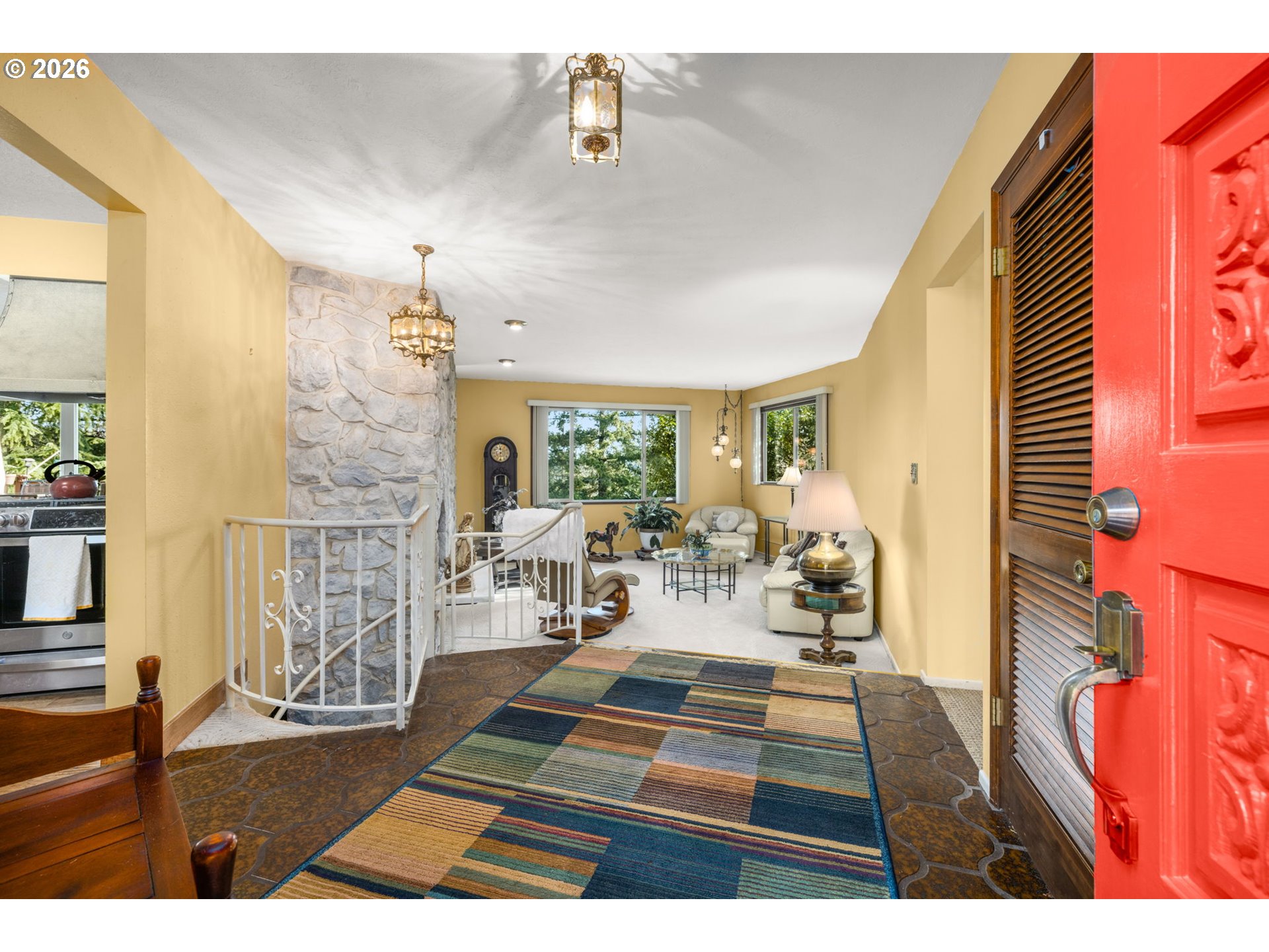 16020 Southeast Monner Road Happy Valley, OR 97086 - Photo 5 of 38 a living room with furniture a rug and a chandelier