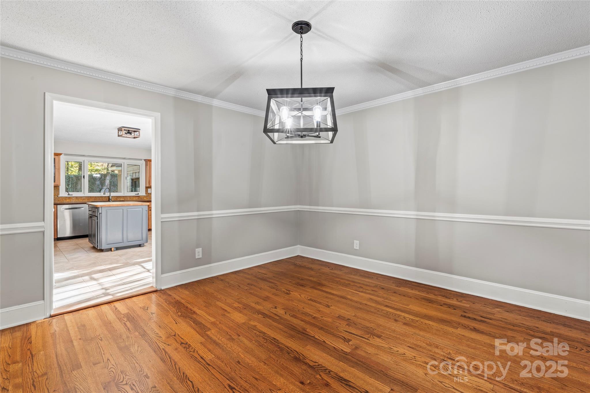 3616 Spokeshave Lane Matthews, NC 28105 - Photo 12 of 45 a view of an empty room with wooden floor and a window