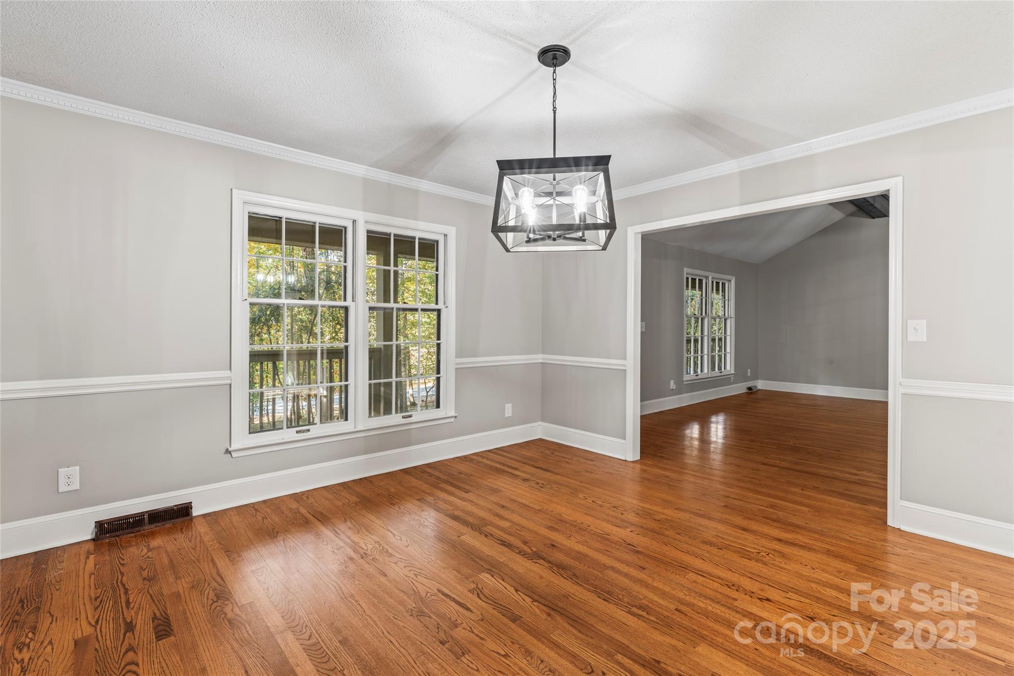 3616 Spokeshave Lane Matthews, NC 28105 - Photo 13 of 45 a view of an empty room with wooden floor and a window