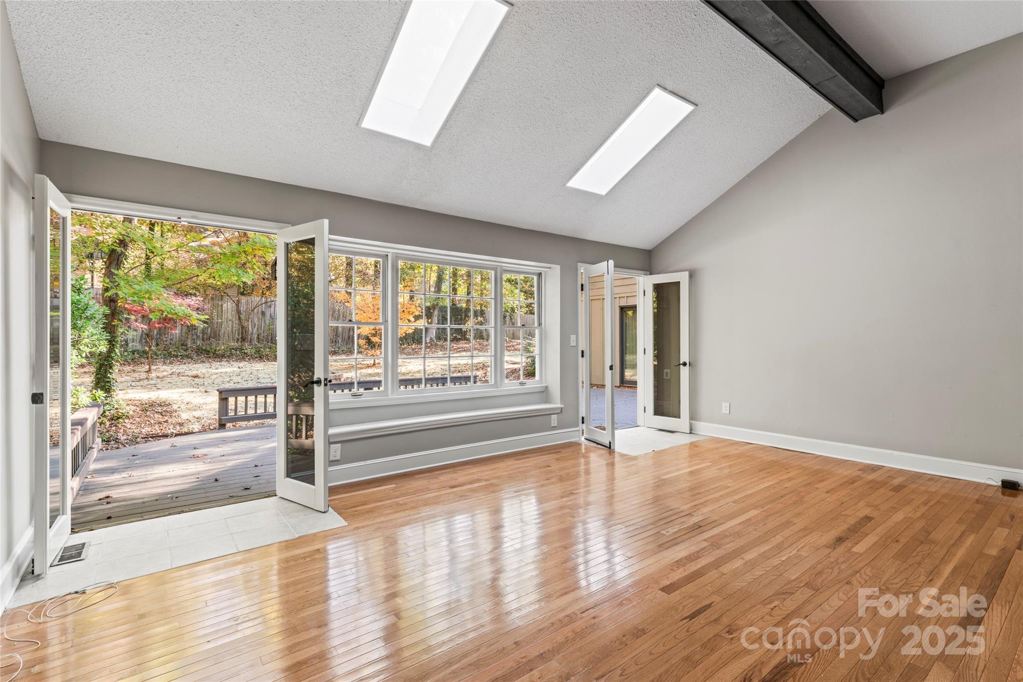 3616 Spokeshave Lane Matthews, NC 28105 - Photo 18 of 45 a view of an empty room with wooden floor and a window