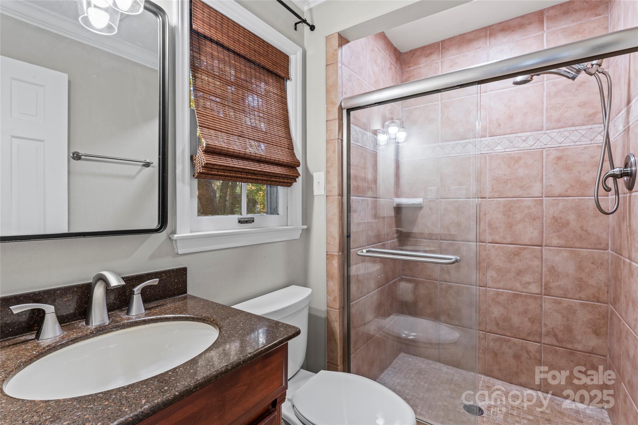 3616 Spokeshave Lane Matthews, NC 28105 - Photo 27 of 45 a bathroom with a sink toilet a mirror and shower