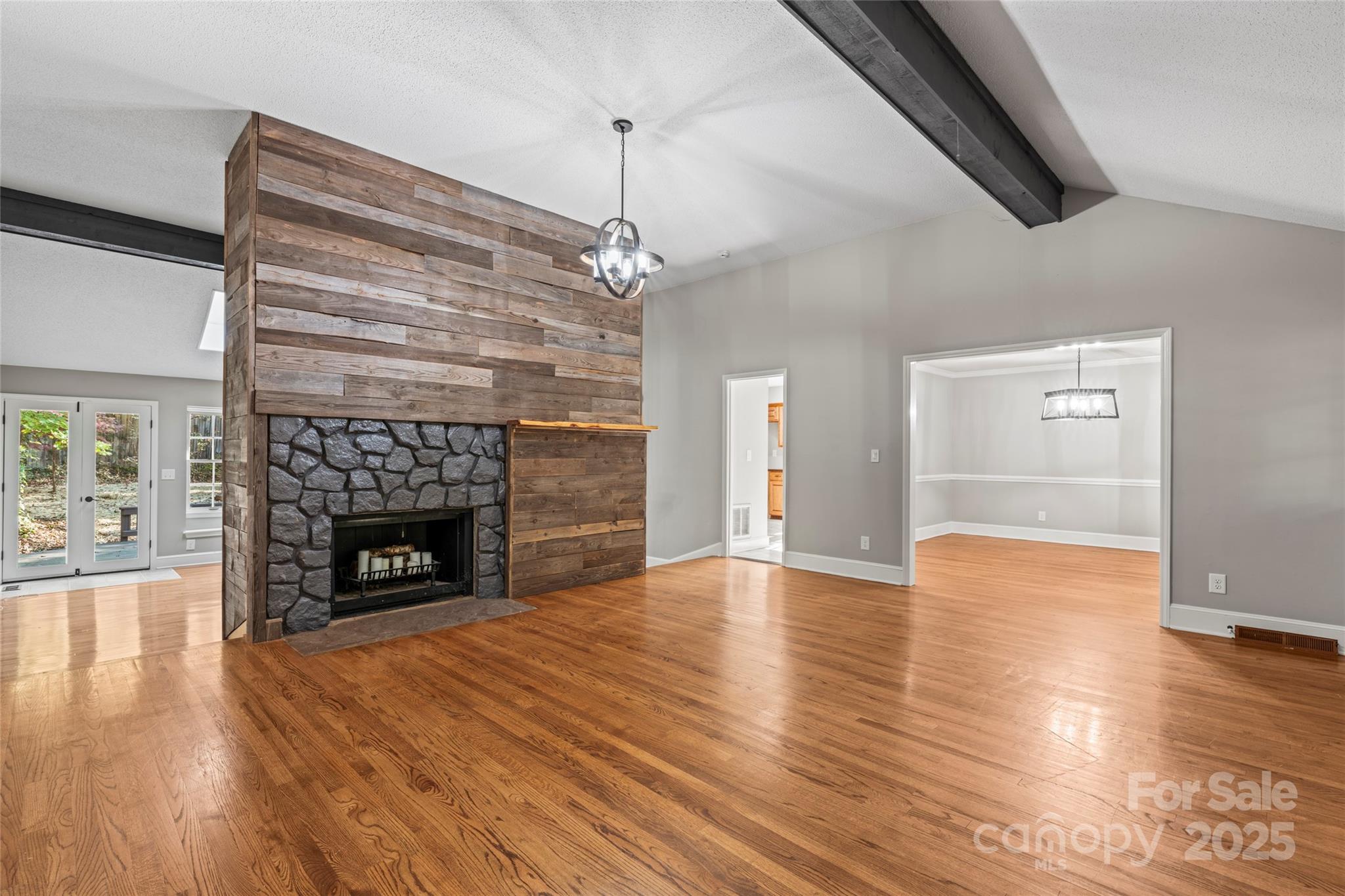 3616 Spokeshave Lane Matthews, NC 28105 - Photo 9 of 45 a view of an empty room with wooden floor fireplace and a window