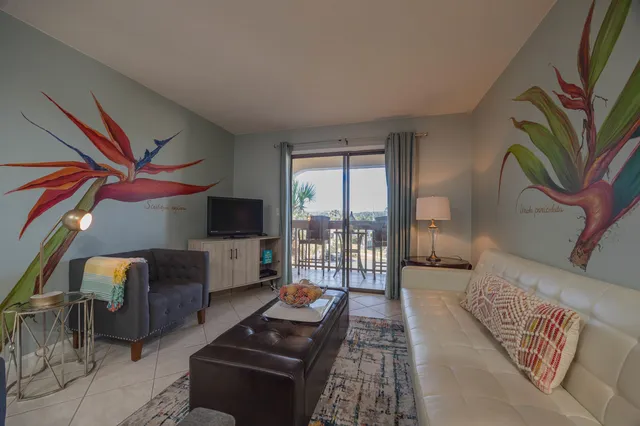 a living room with furniture and a potted plant