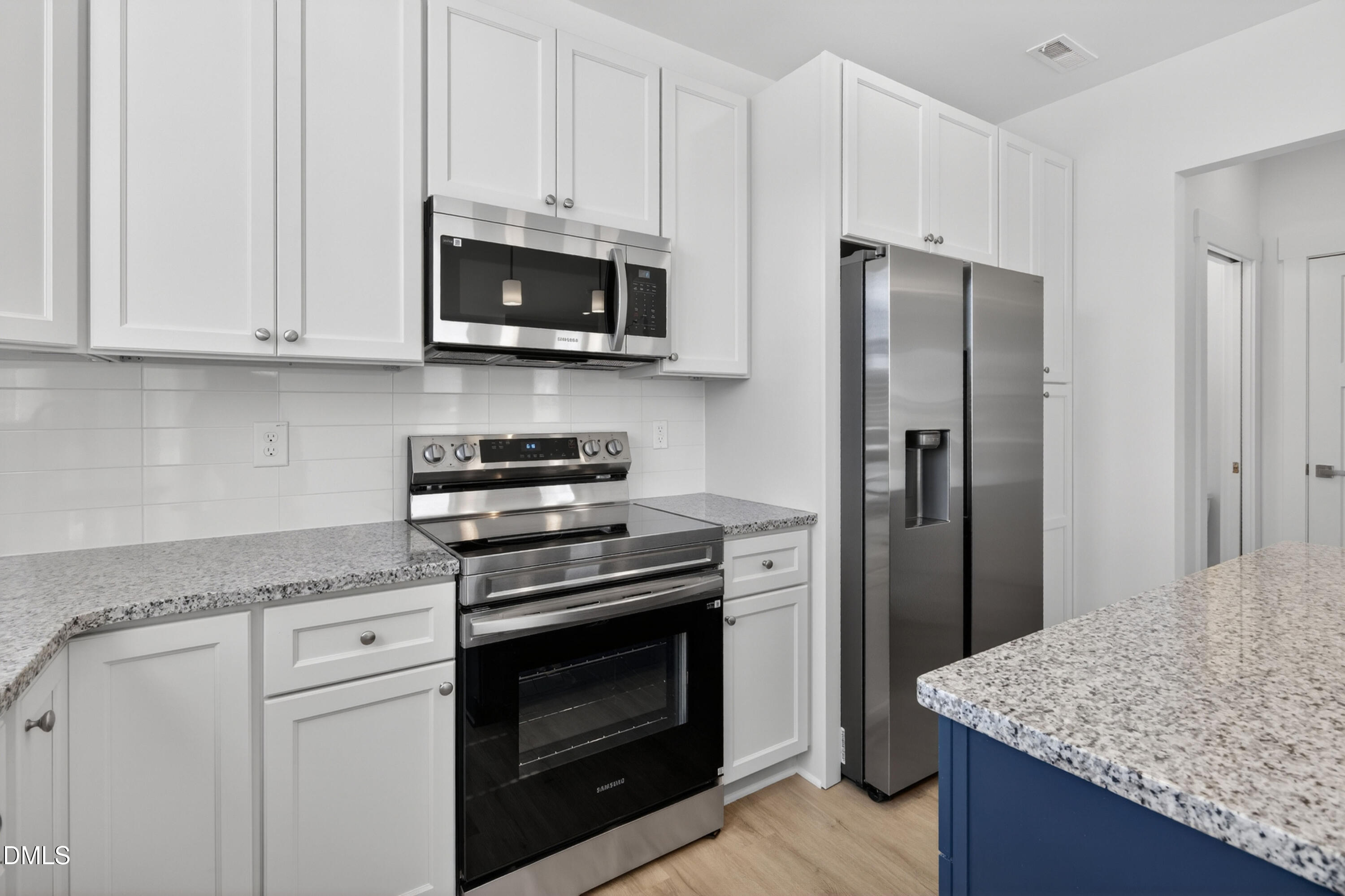 1238 Hurdle Mills Road Roxboro, NC 27573 - Photo 21 of 50 a kitchen with stainless steel appliances granite countertop white cabinets and a granite counter tops