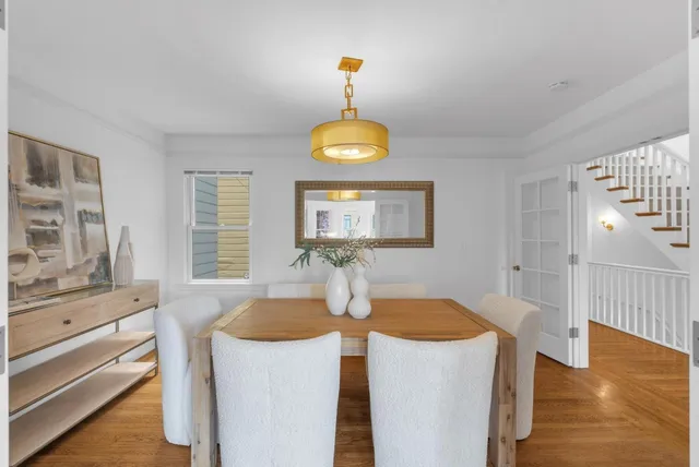 a kitchen with a table and a chandelier