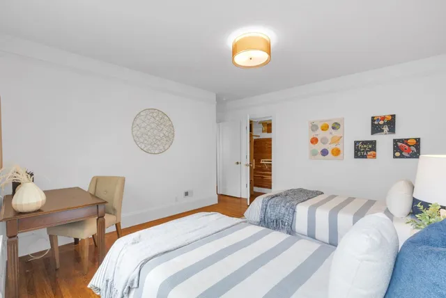 a bedroom with a bed and a chair