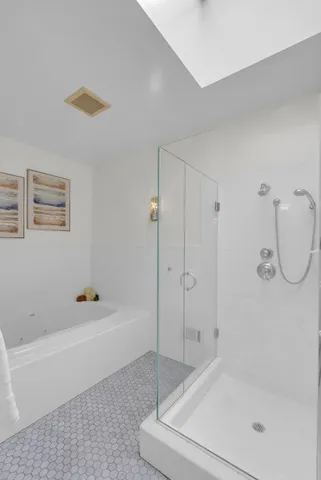 a bathroom with a tub shower and a sink