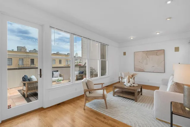 a living room with furniture and a floor to ceiling window