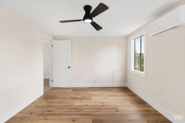 an empty room with closet and windows