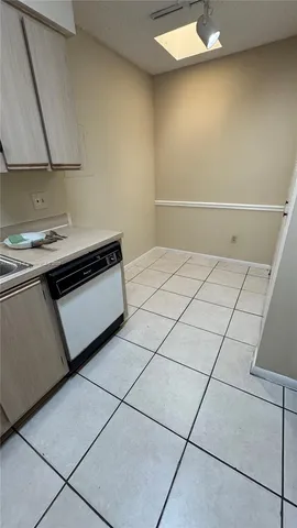 a kitchen with a sink and a stove top oven