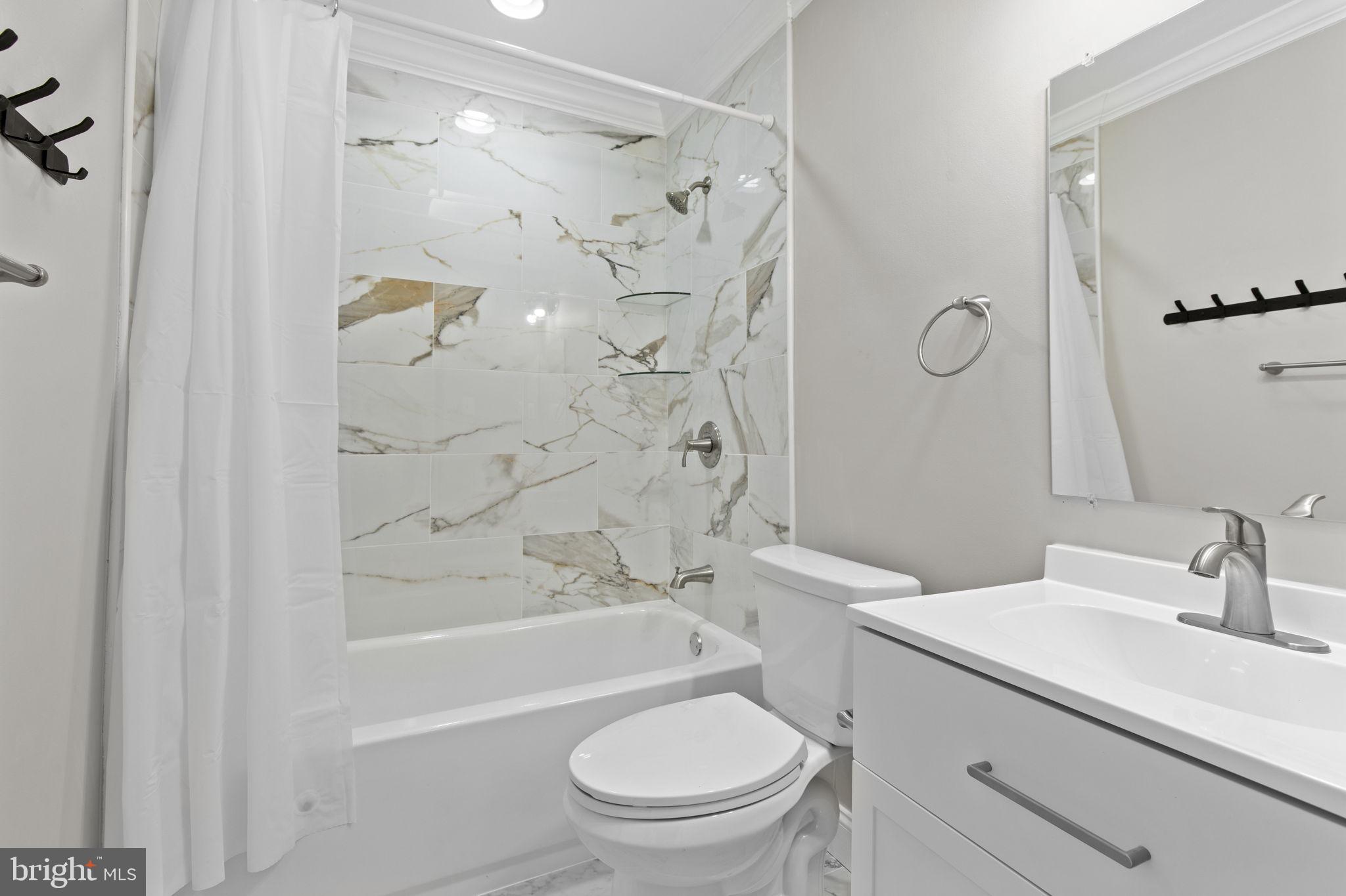 7571 Westfield Road Dundalk, MD 21222 - Photo 11 of 21 a bathroom with a sink toilet and shower