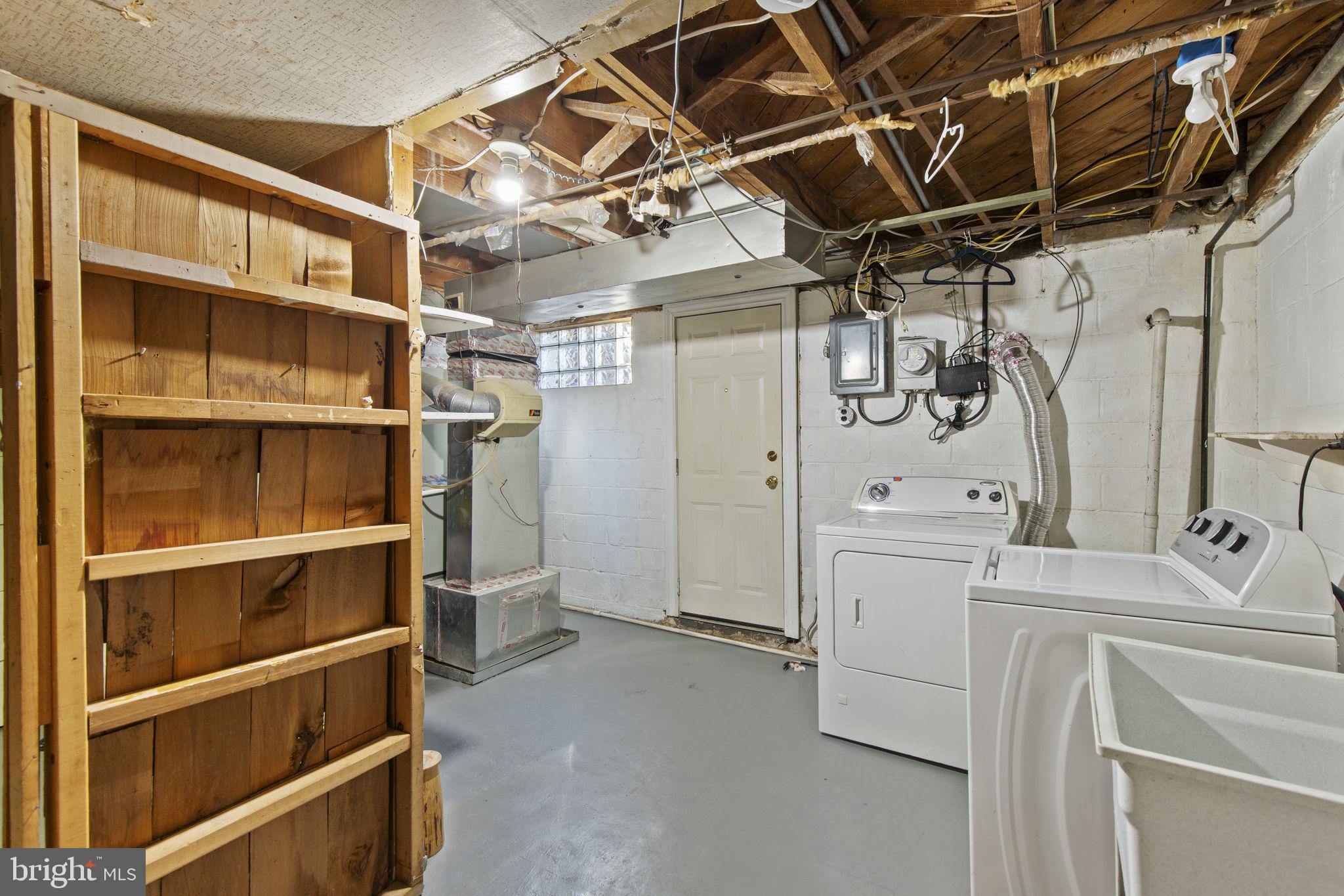 7571 Westfield Road Dundalk, MD 21222 - Photo 14 of 21 a utility room with cabinets dryer and washer
