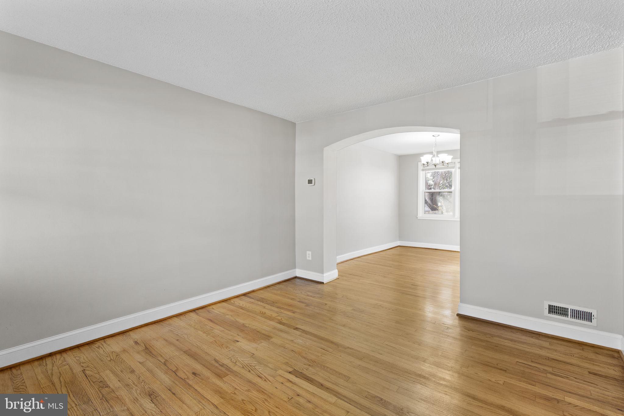 7571 Westfield Road Dundalk, MD 21222 - Photo 3 of 21 an empty room with wooden floor and windows