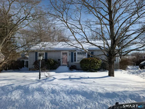 a view of a house with a yard covered in snow