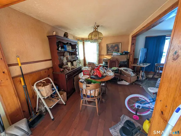 a living room with furniture a window and gym equipment
