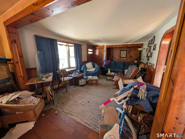 a living room with furniture fireplace and a large window
