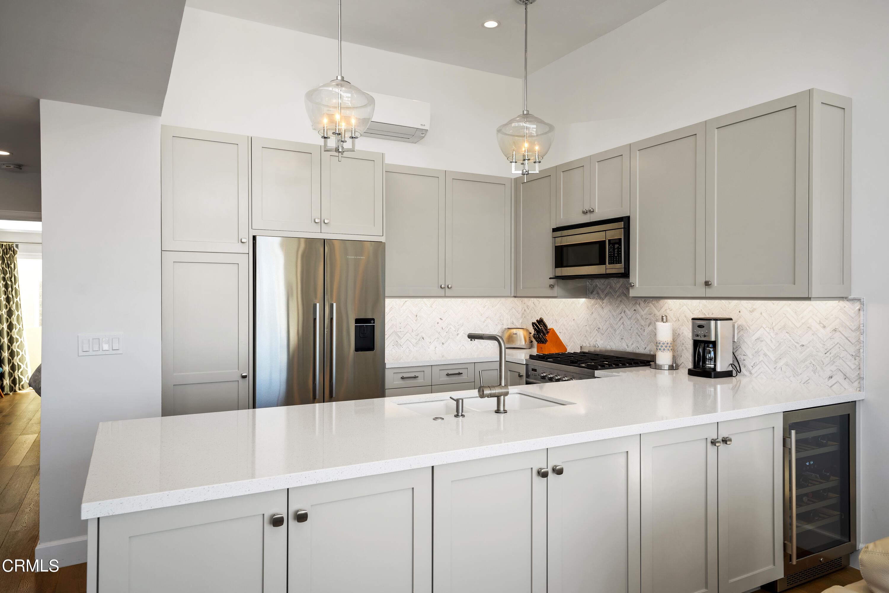 3545 Sunset Lane Oxnard, CA 93035 - Photo 11 of 41 a kitchen with a sink a center island a stove cabinets and stainless steel appliances