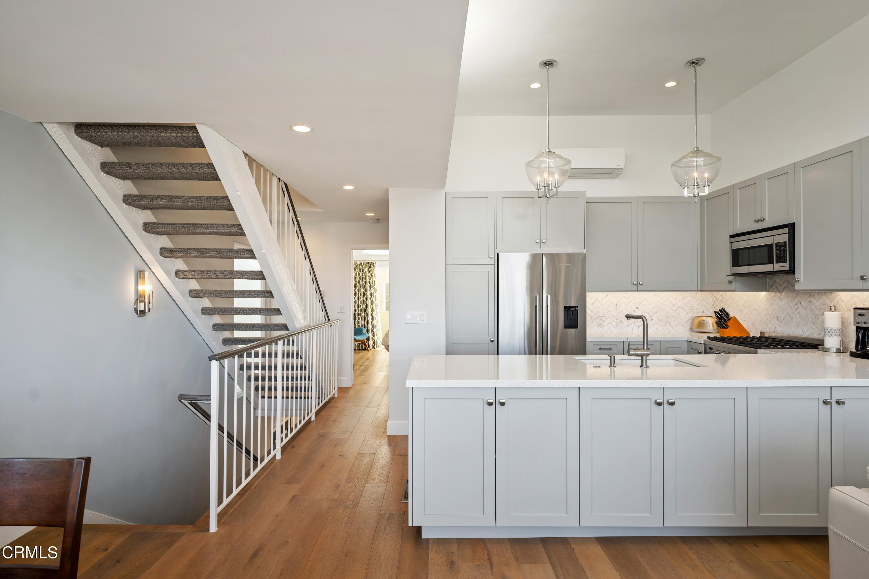 3545 Sunset Lane Oxnard, CA 93035 - Photo 18 of 41 a kitchen with kitchen island white cabinets and stainless steel appliances