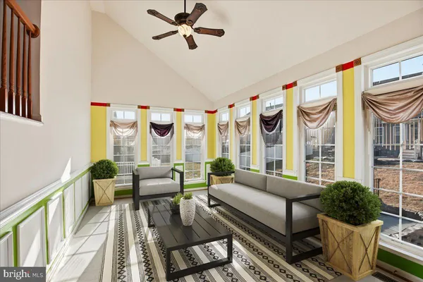 a view of a dining room with furniture a chandelier and wooden floor