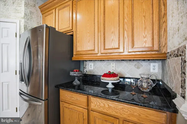 a bathroom with a granite countertop sink a toilet and bathtub