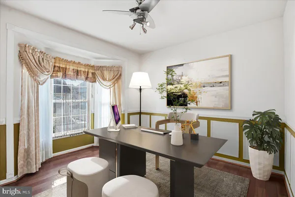 a view of empty room with window and ceiling fan