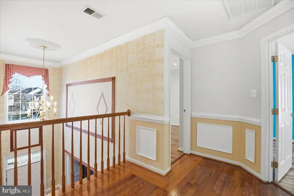 a view of an empty room with closet and a window