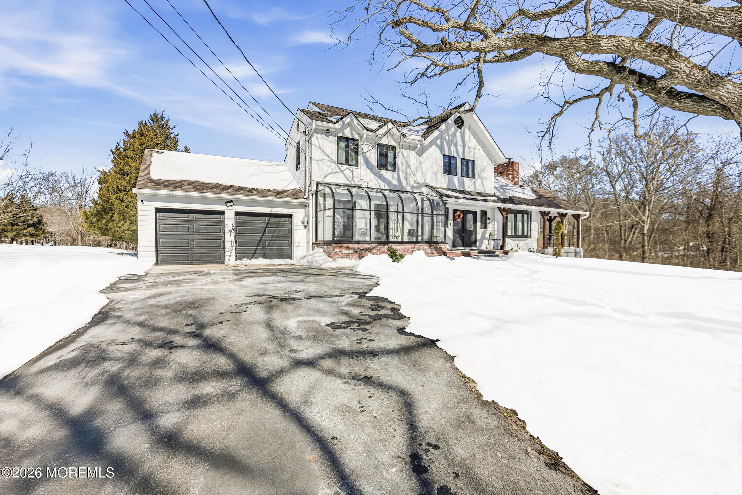 a view of residential houses with snow on the road