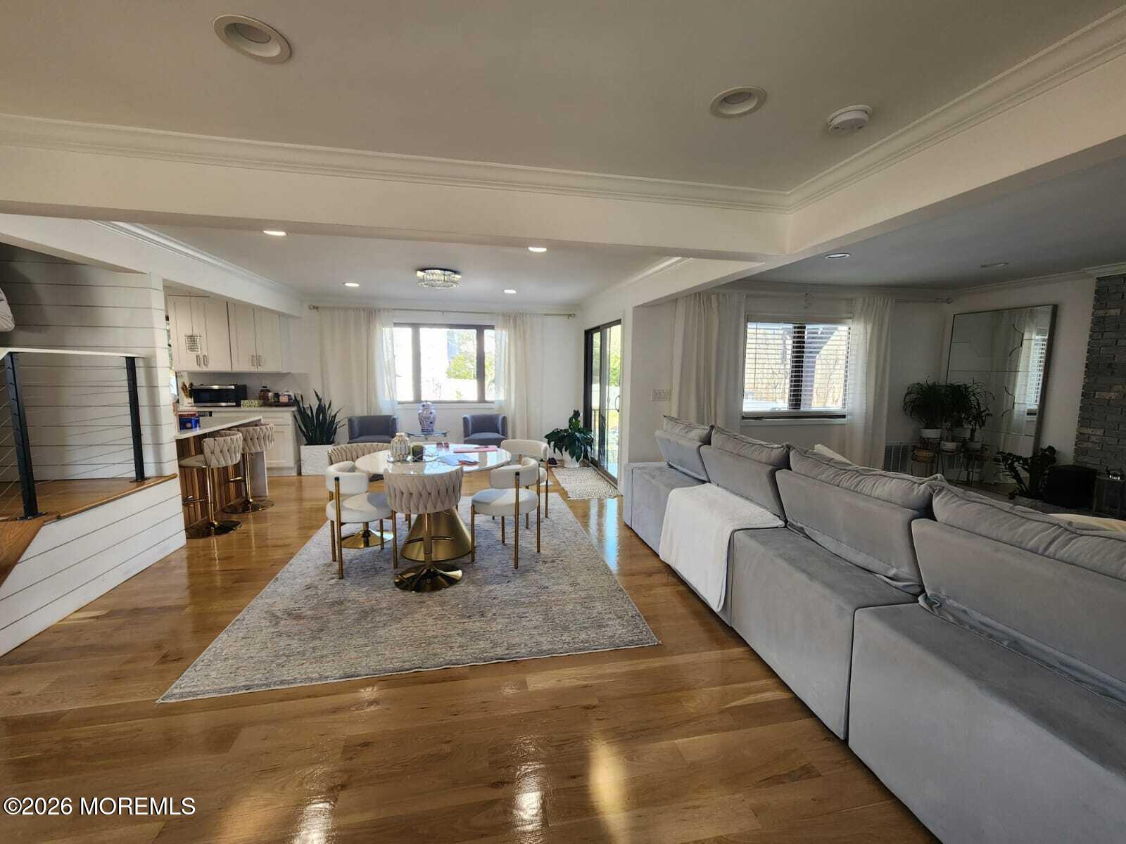 1120 Farmingdale Road Jackson, NJ 08527 - Photo 2 of 8 a living room with furniture and a chandelier
