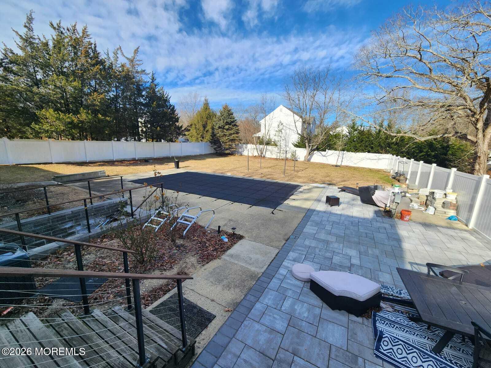 1120 Farmingdale Road Jackson, NJ 08527 - Photo 6 of 8 a view of swimming pool with seating space and trees in the background