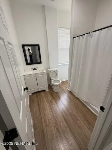 a room with a window and a wooden floor