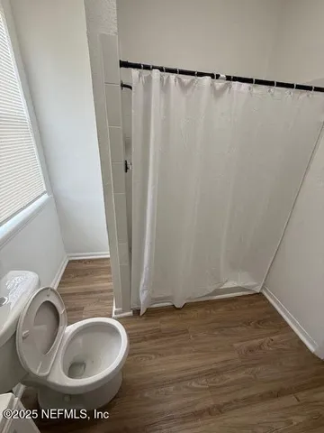 a bathroom with a sink toilet and a mirror