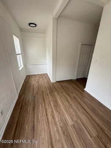 a view of a room with wooden floor