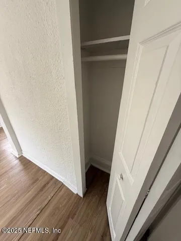 a view of front door with wooden floor