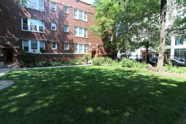 4716 North Racine Avenue, Unit 2E Chicago, IL 60640 - Photo 2 of 19 a view of a house with a big yard