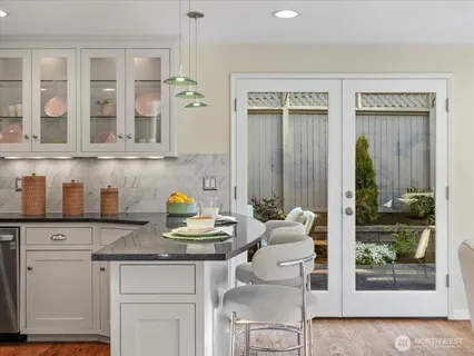 a kitchen with stainless steel appliances granite countertop a stove and cabinets