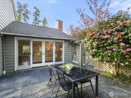 a backyard of a house with table and chairs
