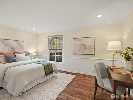 a bedroom with double bed and a window