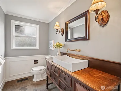 a bathroom with a sink a mirror and a toilet