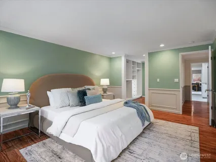 a bedroom with a bed and a mirror