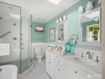 a spacious bathroom with a granite countertop sink mirror and a toilet