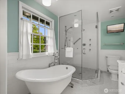 a white bath tub sitting next to a toilet