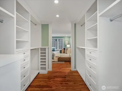 a view of walk in closet and bedroom